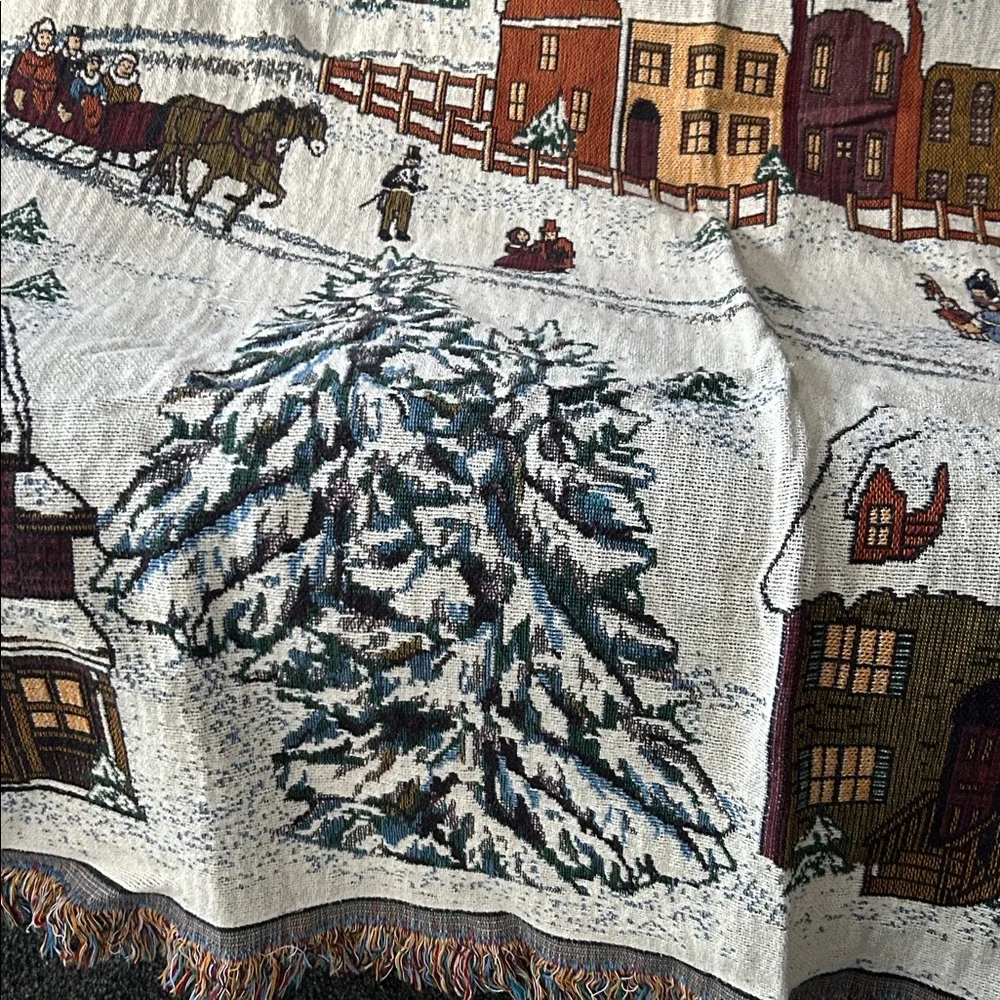 woven tapestry throw blanket featuring a winter village scene fringe edges